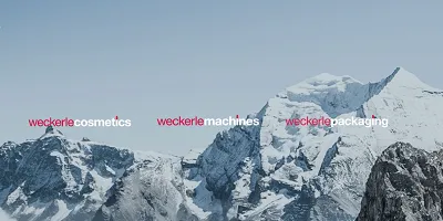 Snow-covered mountains with the words 'weckerle cosmetics', 'weckerle machines', and 'weckerle packaging' overlaid.